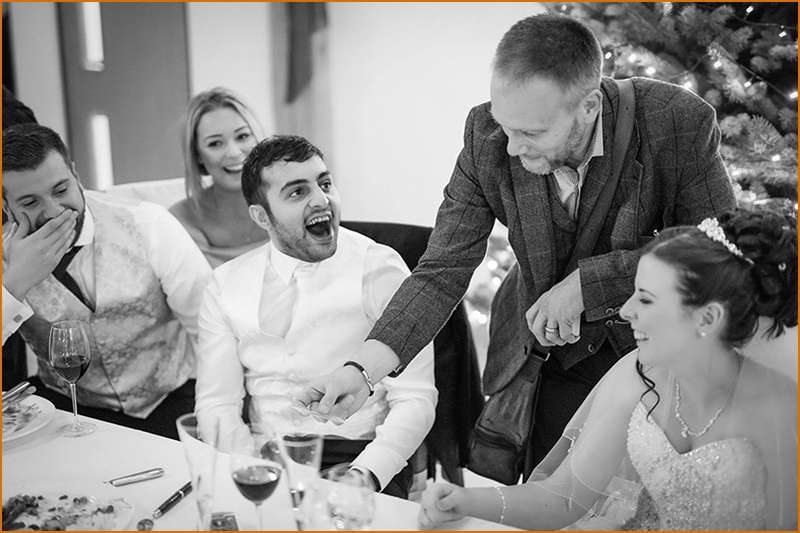 Wedding Magician and MC Simon Alexander Performs to Laughing Crowd At The Table